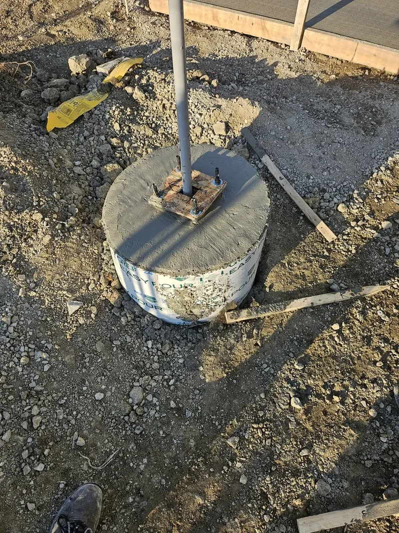 Concrete gazebo footing poured into a sonotube with a saddle bracket set below the frost line