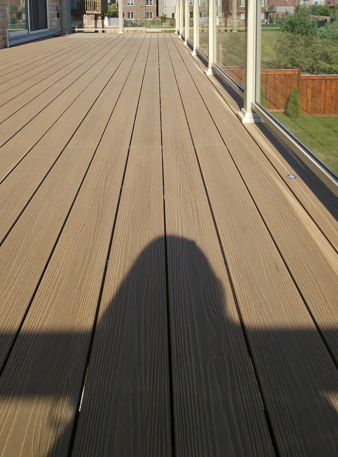 Composite boards on one of our decks, the same low-maintenance material we use to clad pergola posts and beams