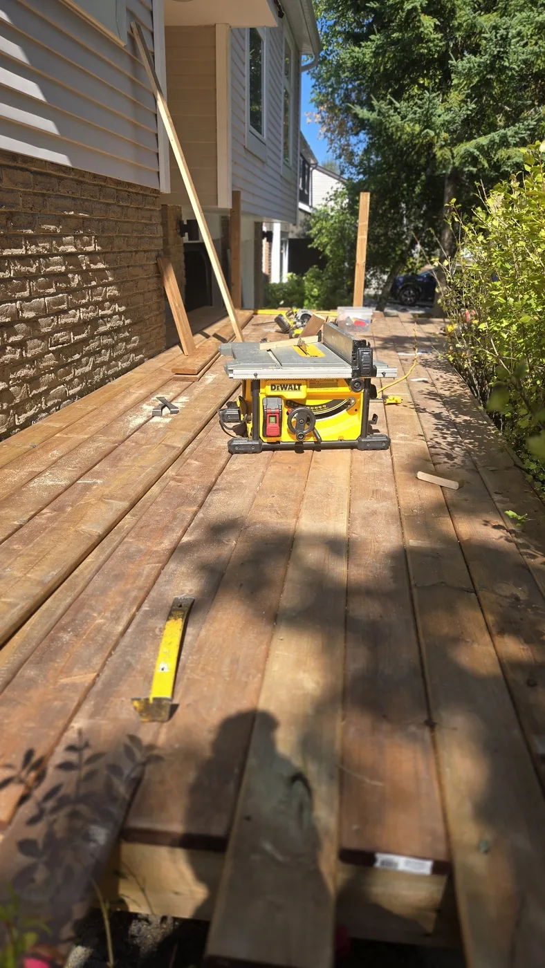 Table saw set up on an old deck while boards are replaced