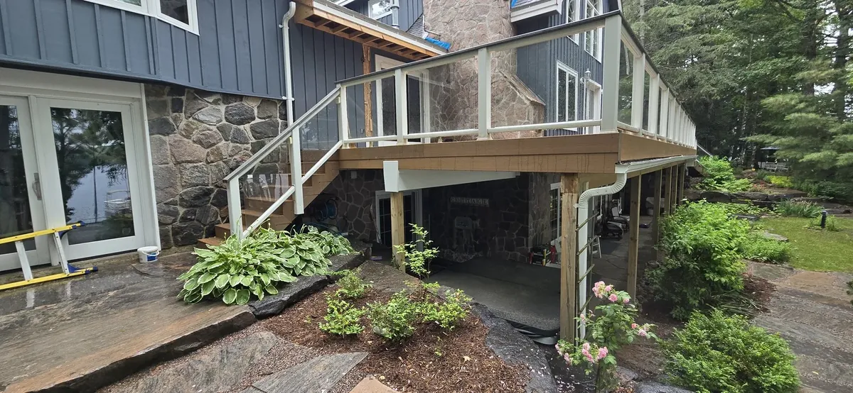 Elevated cedar deck and stairs above a rock garden, built by XP Decking